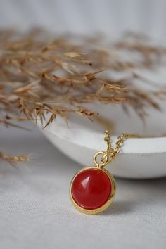 Red jade necklace gold plated stainless steel 10mm gemstone round pendant jewelry gift. ⭐ Handmade beautiful gold pendant necklace with jade red. ⭐ Materials used:- * Semiprecious gemstone jade red cabochon,  * High quality gold plated stainless steel necklace chain, ** Length of the chain:- app. 40cm/ 42cm/ 45cm  * 10mm high quality gold plated stainless steel pendant. ⭐ For Matching studs please visit our shop. https://www.etsy.com/de-en/listing/1286035499/red-jade-stud-earrings-gold-gemstone https://www.etsy.com/listing/1393889068/red-jade-stud-earrings-gold-minimalist ⭐ Also all gemstone jewelry options are available in our shop. Please visit our shop for more details. https://www.etsy.com/shop/Anvira10 ⭐ Packing: Carefully packaged and ready to give as a gift. If you want to add a not Beautiful Gold Pendants, Red Pendant Necklace, Red Stone Necklace, Red Pendant, Minimalist Necklace Gold, Red Jade, Red Pendants, Round Pendant Necklace, Red Necklace