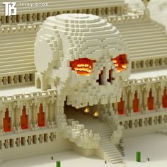 a close up of a building made out of legos with an orange light in the eyes