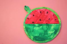 a watermelon patch on top of a pink wall with green and red material