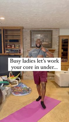 a man is standing on a yoga mat in the middle of a living room with a sign that says busy ladies let's work your core in under