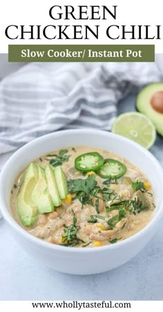 a bowl of green chicken chili with avocado and cilantro on the side