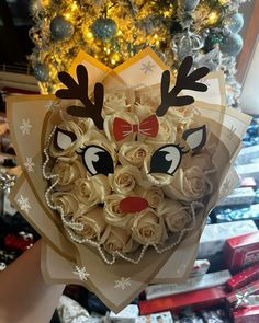 a bouquet of roses in the shape of a reindeer's head is being held by someone