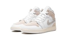 The Air Jordan 1 Mid SE Craft GS “White/Sail” is the youth sizing of the lifestyle sneaker with a deconstructed design.  The “White/Sail” features an “inside-out” look that gives the Jordan 1 Mid SE Craft a contemporary vibe.  The perforated leather toe panel sits on top of the toe cap—on a standard Air Jordan 1, this is reversed.  The suede overlays are designed in an undyed, natural hue that would typically appear on the inside of the shoe.  A tan suede Swoosh with orange reinforced bartacking Cream Jordans, Cream Color Jordans, White Mid-top Jordan Shoes For Streetwear, Luxury White Mid-top Jordan Shoes, Luxury Mid-top White Jordan Shoes, Air Jordan 1 Mid Se, Preppy Shoes, Nike Dunk High, Air Jordan 3