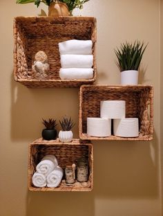 three baskets with towels and plants on them