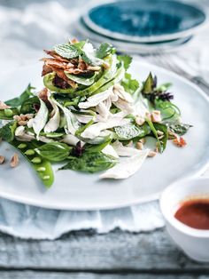 a white plate topped with salad and dressing