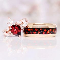 Red Fire Opal, Natural Red Garnet & Galaxy Blue Sandstone Couples Ring Set, a symbol of profound love, cosmic unity, and harmonious commitment that transcends the boundaries of time and space.►Crafted with precision and adorned with the finest materials, this matching ring set is a breathtaking celebration of your unique bond. The bands feature a blend of stunning elements. The centerpiece of his ring is a fiery Red Fire Opal, radiating warmth and passion. The opal's deep crimson hue symbolizes Red Jewelry With Accent Stones For Gift, Red Gemstone Accented Anniversary Rings, Red Garnet Promise Jewelry, Red Garnet Promise Ring, Red Rings With Gemstone Accents For Anniversary, Red Promise Rings With Accent Stones, Red Jewelry With Accent Stones For Promise, Anniversary Red Rings With Gemstone Accents, Red Birthstone Jewelry For Promise