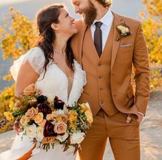 a bride and groom posing for a wedding photo