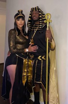 a man and woman dressed up in egyptian garb posing for a photo while wearing costumes