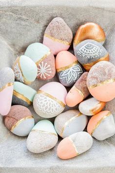 a bowl filled with lots of different colored rocks