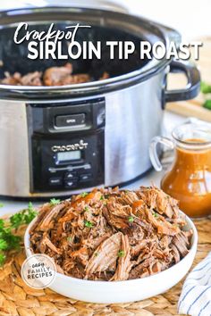 crockpot sirloin tip roast in a white bowl with parsley on the side