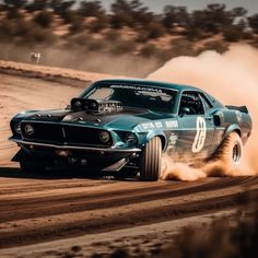 a car driving down a dirt road with dust coming out of the tires and wheels