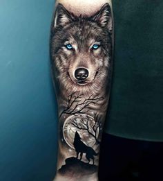 a man's arm with a wolf and moon tattoo on it