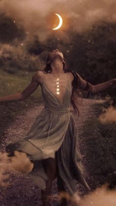 a woman in a dress is walking down a path with her arms outstretched and the moon above her head