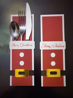 two forks and spoons are placed in front of a christmas card