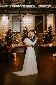 a bride and groom share their first dance at the wedding reception in an industrial building