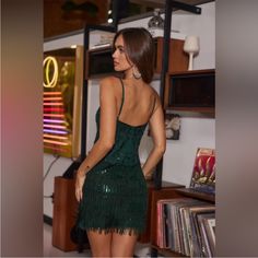 a woman in a green dress is looking back