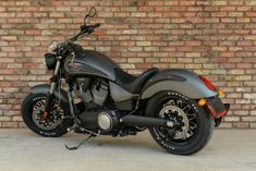 a motorcycle parked in front of a brick wall