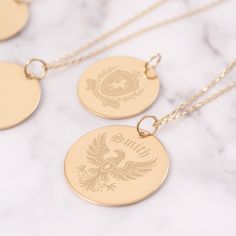 Embrace your heritage with our Custom Family Crest Necklace, exquisitely crafted from 14K solid gold. Each pendant is meticulously engraved with your personal coat of arms, making it a unique and meaningful gift for any occasion. Perfect for celebrating family history or as a cherished heirloom.  Make this timeless piece yours today and keep your family legacy close to your heart. Material: Solid Gold (real gold, no gold-filled or no gold plated material) Karat: 14 K (585) Available gold color: Yellow, rose, and white Available disc diameter: 12 mm, 14 mm, 16 mm, 18 mm, 20 mm The average thickness of the disc: 0.40 mm *The Chain on the photo is type #3 You can customize the chain length from 16" to 24". The "cable chain" is used for this necklace. You can write for longer and different cha Round Etched Necklaces For Commemoration, Etched Round Necklaces For Commemoration, Etched Necklaces For Commemoration, Round Engraved Necklaces For Commemoration, Vintage Jewelry With Engraved Text For Gift, Heirloom Engraved Necklace For Gift, Traditional Jewelry With Engraving Option For Gift, Traditional Engraved Jewelry As Gift, Traditional Jewelry With Engraving Option As Gift