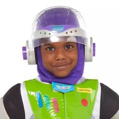 a young boy wearing a buzz lightyear costume and headgear with ear muffs