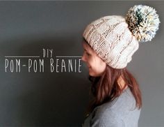 a woman wearing a white knitted pom - pom beanie with the words diy pom - pom beanie