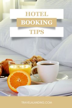 a tray with orange slices, coffee and other food on it next to a hotel bed