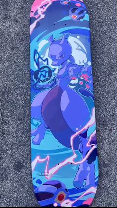 a skateboard with an image of pokemon on it sitting on the ground in front of some concrete