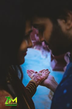 a man and woman holding their hands together