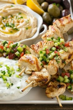 grilled chicken skewers with greek dip and vegetables