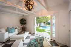 a living room filled with furniture and a pool