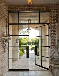 an open glass door leading into a garden