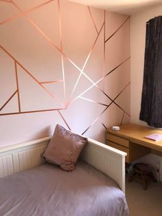 a bedroom with a bed, desk and window covered in pink papered wallpaper