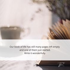 an open book sitting on top of a table next to a coffee cup and saucer