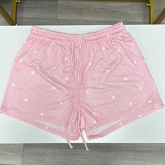 Pink Short With White Hearts And Pockets Trendy Bottoms With Heart Print For Summer, White Heart Print Bottoms For Summer, Trendy Summer Bottoms With Heart Print, Trendy Heart Print Bottoms For Summer, Trendy Heart Print Summer Bottoms, Casual White Bottoms With Heart Print, Pink Heart Print Bottoms For Summer, Cute Pink Cotton Pajama Shorts, Casual Pink Athletic Shorts With Built-in Shorts