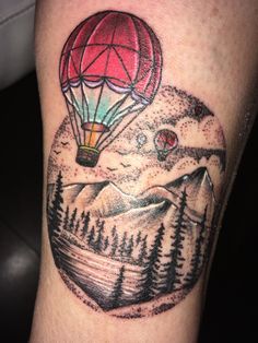 a hot air balloon tattoo on the leg