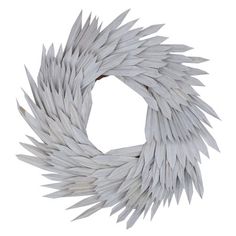 a wreath made out of white feathers on a white background