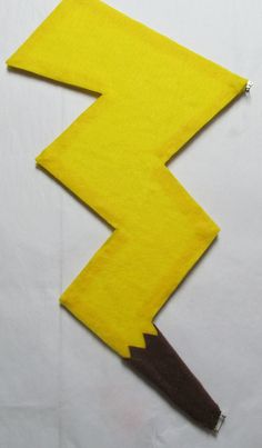 a yellow piece of paper with a pencil sticking out of it's center and the shape of a lightning