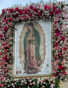 an image of the virgin mary surrounded by flowers