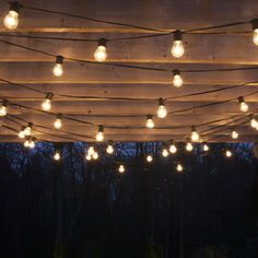 the lights are hanging from the wooden structure