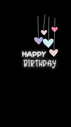 the words happy birthday are lit up in white and pink hearts on a black background