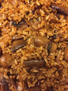 rice and mushrooms are mixed together in a dish