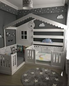 a baby's room with two cribs and a rug on the floor