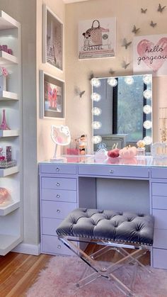 a room with a vanity, stool and mirror