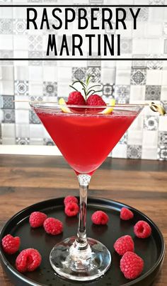 raspberry martini in a glass on a black tray