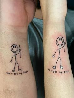 two people with matching tattoos on their arms