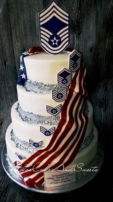 a three tiered cake with an american flag on the top and two flags on the bottom