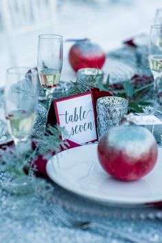 the table is set with an apple and place cards for guests to write their names