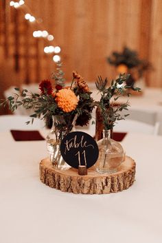 the centerpieces were placed on top of wood slices and decorated with greenery