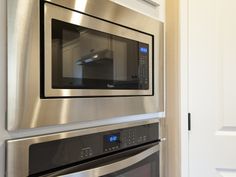 a stainless steel oven and microwave built into the wall