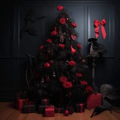 a black christmas tree with red roses on it