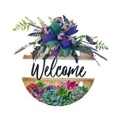 the welcome sign is decorated with succulents and greenery, along with a purple bow